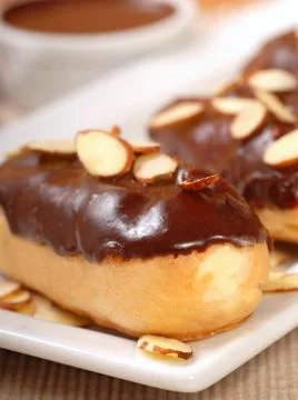 Delicious chocolate eclairs with almonds Stock Photos