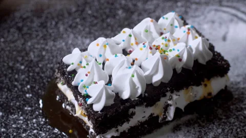 Delicious chocolate sponge cake filled with creamy layers rotating on a tray Stock Footage 169839620