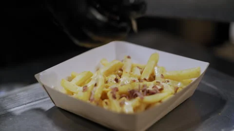 Delicious Close-Up of Bacon on Cheese-Covered Fries Stock-Footage 307086980