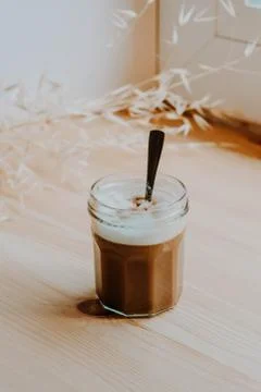 Delicious Coffee with withe milk foam. Coffee in a workspace table corner. Un Stock Photos