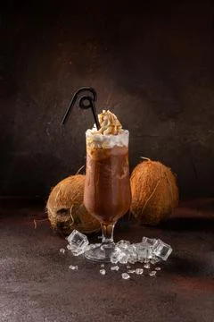 Delicious cold refreshing ice coffee in cocktail glass with coconut Stock Photos