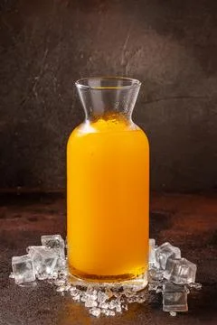 Delicious cold refreshing orange smoothie drink in cocktail glass Stock Photos