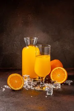 Delicious cold refreshing orange smoothie drink in cocktail glass Stock Photos