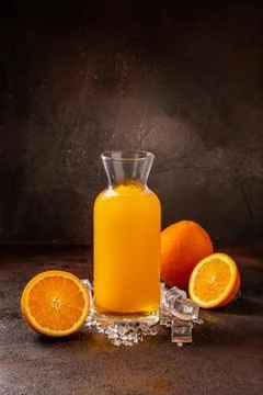 Delicious cold refreshing orange smoothie drink in cocktail glass Stock Photos