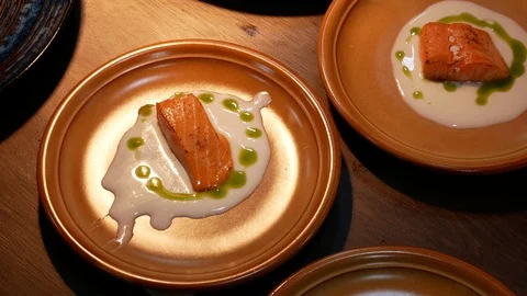 Delicious cooked salmon fish fillets. Food preparation in the restaurant. Stock Footage 96160611