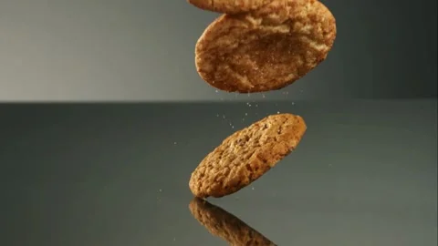 Delicious cookies falling and bouncing on a dark surface Video stock 327514126