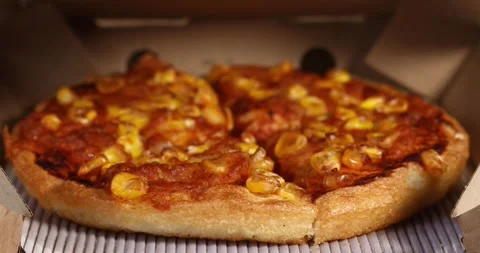 Delicious corn pizza in an open cardboard box with focus shift, Food concept Stock Footage 298033415