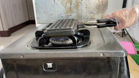 Delicious craffle or waffles in the grill on the stove. delicious and crunchy Stock Footage 227698053