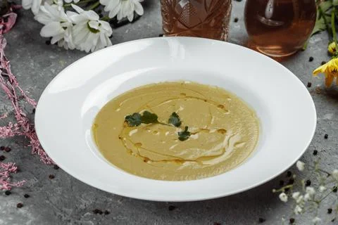 Delicious cream soup with bread on the table Stock Photos