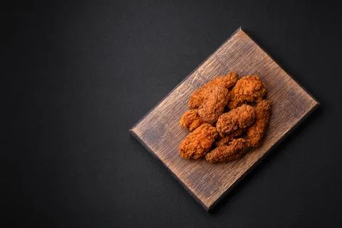 Delicious crispy breaded chicken wings grilled with spices and herbs Stock Photos