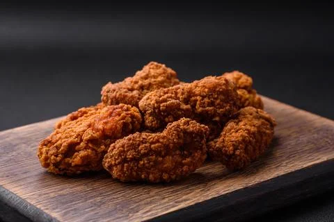 Delicious crispy breaded chicken wings grilled with spices and herbs Stock Photos