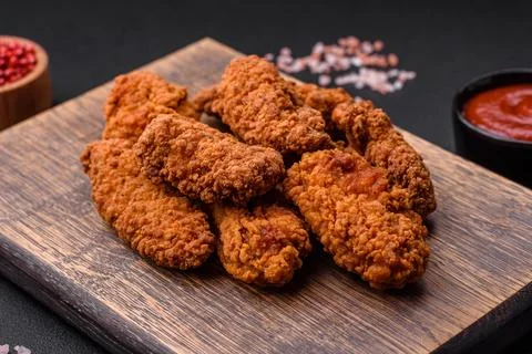 Delicious crispy breaded chicken wings grilled with spices and herbs Stock Photos