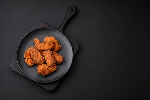 Delicious crispy breaded chicken wings grilled with spices and herbs Stock Photos