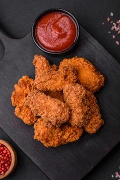Delicious crispy breaded chicken wings grilled with spices and herbs Stock Photos