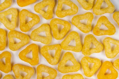Delicious crispy corn chips triangular shape with spices on a white backgroun Foto stock