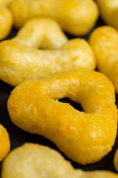 Delicious crispy corn chips triangular shape with spices on a black backgroun Stock Photos