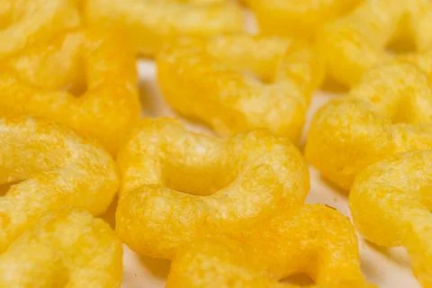 Delicious crispy corn chips triangular shape with spices, macro. 스톡 사진