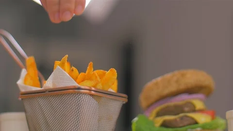 Delicious crispy fried potatoes. Sprinkle with red pepper. Slow motion Stock-Footage 107515744