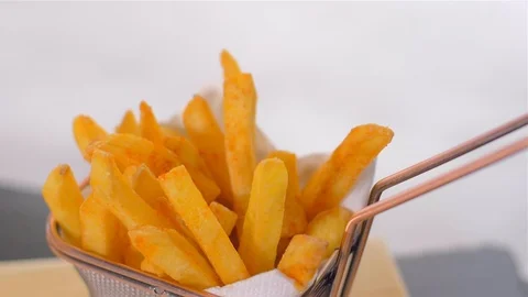 Delicious crispy fried potatoes. Sprinkle with red pepper. Slow motion Stock Footage 107515809