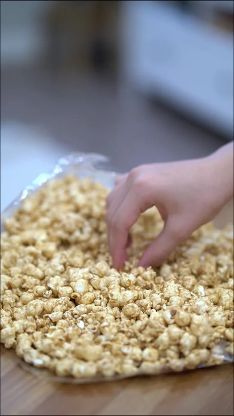 Delicious crunchy popcorn being picked by fingers in a tempting  Stock-Footage 342270957