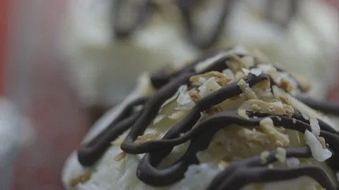 Delicious cupcake in display case of store front Stock Footage 104867328