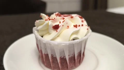 Delicious cupcake with icing on a plate. Stock Footage 295373259