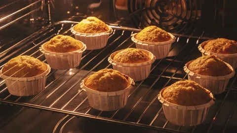 Delicious cupcakes baking in the oven, time lapse. Banana muffins. Stock Footage 166237174