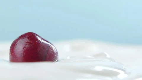 A delicious dark red cherry in sour cream Stock Footage 138369534