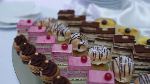 Delicious decorated candy bar, sweets on tables for wedding reception Stock Footage 66443404