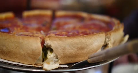 Delicious deep-dish pizza being served at a local restaurant in Chicago Stock Footage 281705088