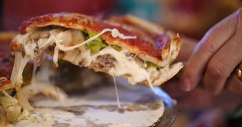 Delicious deep dish pizza loaded with toppings in Chicago Stock Footage 281705210