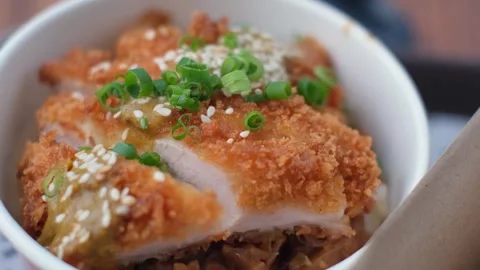 Delicious deep-fried chicken with savory sauce on rice bowl Stock Footage 340665523