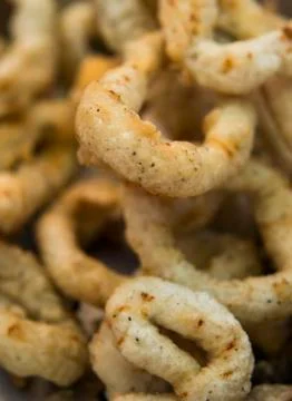 Delicious deep fried rings of squid close up. Stock Photos
