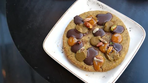 Delicious dessert with chocolate and nuts on a plate Stock Footage 314591334
