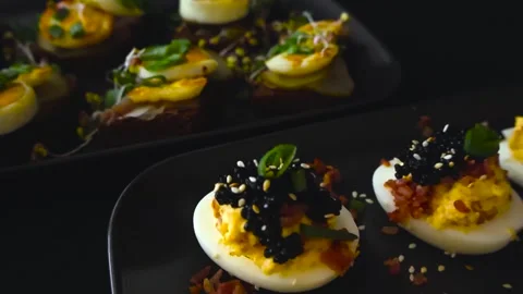 Delicious deviled eggs appetizer with black caviar Stock Footage 331438999
