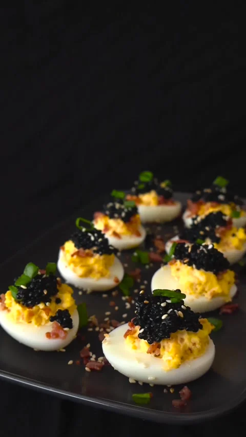 Delicious Deviled Eggs With Black Caviar and Bacon Stock Footage 332620397