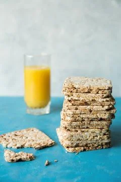 Delicious, diet loaves in a stack on a blue background close up. A glass of.. Stock Photos