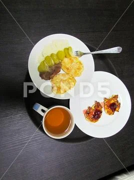 Delicious dinner consisting of a main course, drink and dessert Stock Photos