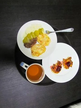 Delicious dinner consisting of a main course, drink and dessert Stock Photos