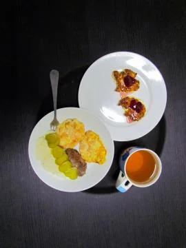 Delicious dinner consisting of a main course, drink and dessert Stock Photos
