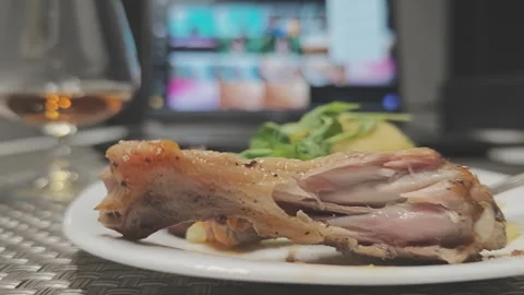 Delicious dinner with roasted poultry leg, fresh salad, and a glass of cognac Stock Footage 344818058