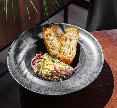 Delicious dish served with toasted bread in a modern dining setting 写真素材