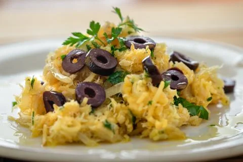 A delicious dish of shredded cod, with potato straw, mixed egg and dark olive Foto stock