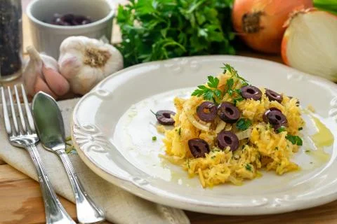 A delicious dish of shredded cod, with potato straw, mixed egg and dark olive Stock Photos