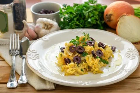 A delicious dish of shredded cod, with potato straw, mixed egg and dark olive Stock Photos