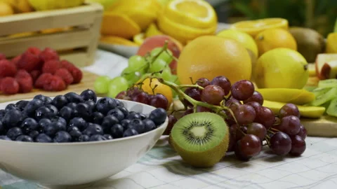 Delicious, diverse fresh fruit scattered across kitchen counter - tracking shot Stock Footage 341228815