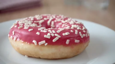 Delicious donut rotating on a plate Stock Footage 66410412