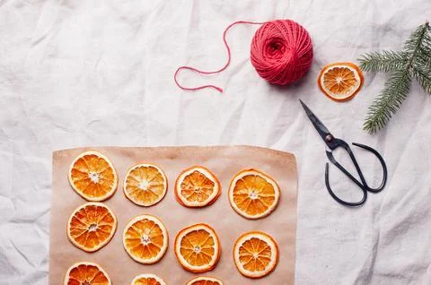 Delicious dried orange on baking sheet and white linen Christmas decoration Stock Photos