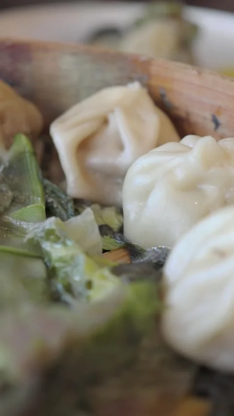 Delicious dumplings served in bamboo steamer at local restaurant Stock Footage 345952935