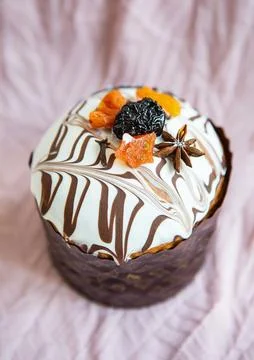A delicious Easter cake, adorned with a marbled chocolate and white icing, is Stock Photos
